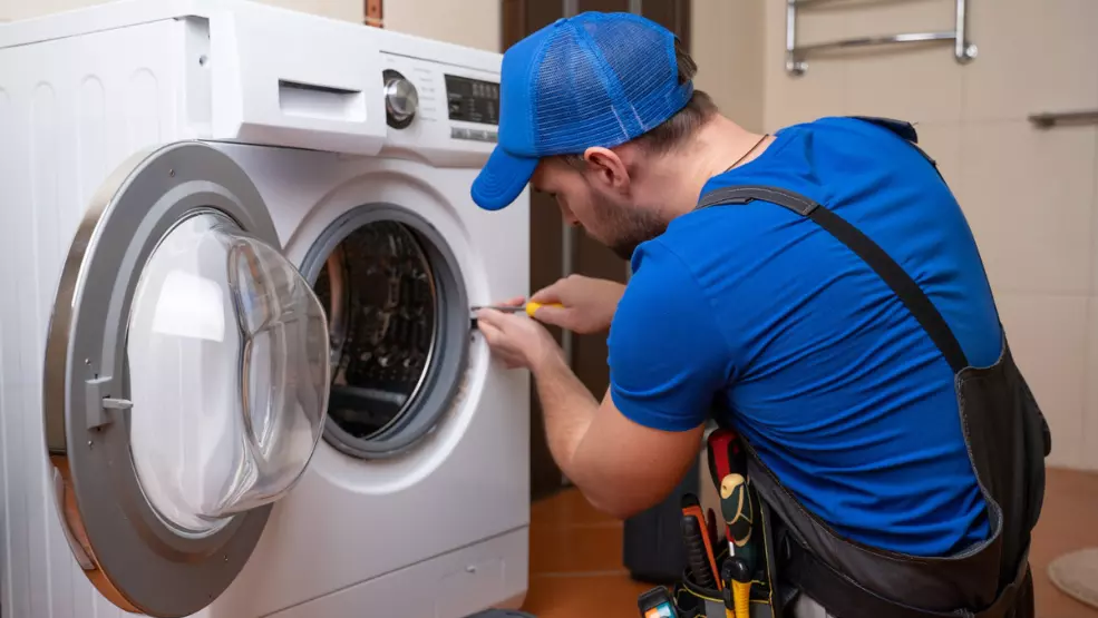 TechPro technician repairing washing machine in Fayetteville NC